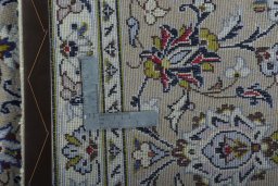 Backside of handmade New Kashan rug showing knot structure and weave density