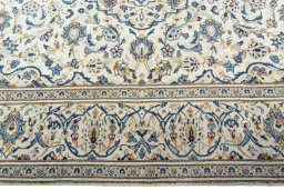 Corner detail of 2000s Kashan rug showing border pattern and Wool pile