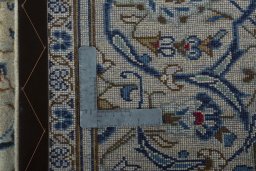 Backside of handmade 2000s Kashan rug showing knot structure and weave density
