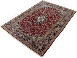 Corner detail of 2000s Kashan rug showing border pattern and Cork pile