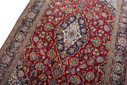 Backside of handmade 2000s Kashan rug showing knot structure and weave density