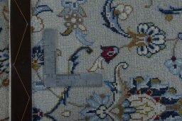 Backside of handmade New Kashan rug showing knot structure and weave density