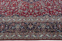 Corner detail of 2000s Kashan rug showing border pattern and Wool pile