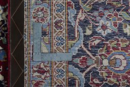 Backside of handmade 2000s Kashan rug showing knot structure and weave density