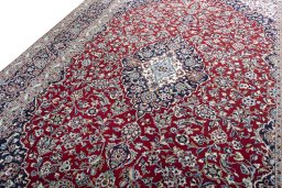 Backside of handmade 2000s Kashan rug showing knot structure and weave density