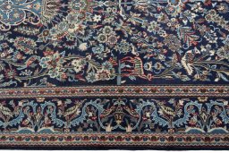 Corner detail of 2000s Kashan rug showing border pattern and Wool pile