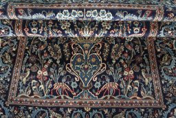 Close-up detail of 2000s Kashan rug from Iran / Persia showing Wool weave
