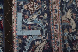 Backside of handmade 2000s Kashan rug showing knot structure and weave density