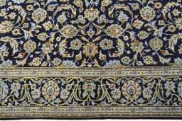 Corner detail of 1970s Kashan rug showing border pattern and Wool pile