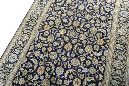 Backside of handmade 1970s Kashan rug showing knot structure and weave density