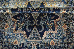 Corner detail of 2000s Kashan rug showing border pattern and Wool pile