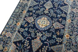 Backside of handmade 2000s Kashan rug showing knot structure and weave density