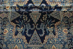 Corner detail of 2000s Kashan rug showing border pattern and Wool pile