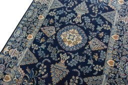 Backside of handmade 2000s Kashan rug showing knot structure and weave density