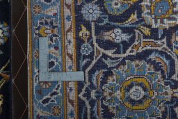 Backside of handmade 1970s Kashan rug showing knot structure and weave density