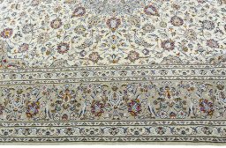 Corner detail of New Kashan rug showing border pattern and Wool pile