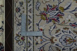 Backside of handmade New Kashan rug showing knot structure and weave density