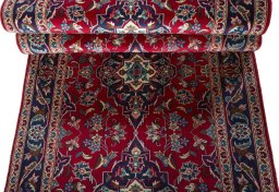 Corner detail of 2000s Kashan rug showing border pattern and Wool pile