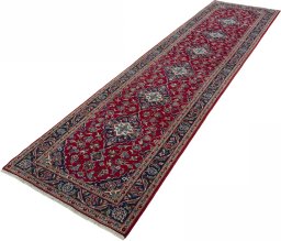 Corner detail of 2000s Kashan rug showing border pattern and Wool pile