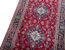 Backside of handmade 2000s Kashan rug showing knot structure and weave density