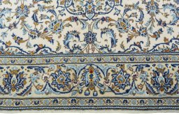 Corner detail of 2000s Kashan rug showing border pattern and Wool pile