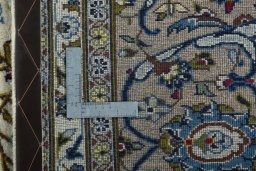 Backside of handmade 2000s Kashan rug showing knot structure and weave density