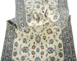 Corner detail of 2000s Kashan rug showing border pattern and Wool pile