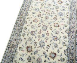 Backside of handmade 2000s Kashan rug showing knot structure and weave density