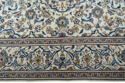 Corner detail of 2000s Kashan rug showing border pattern and Wool pile