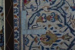 Backside of handmade 2000s Kashan rug showing knot structure and weave density