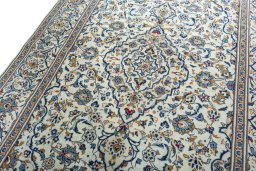 Backside of handmade 2000s Kashan rug showing knot structure and weave density