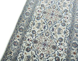 Backside of handmade New Kashan rug showing knot structure and weave density