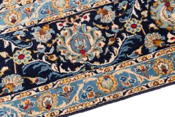 Backside of handmade 1980s Kashan rug showing knot structure and weave density