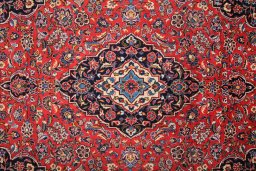Corner detail of 1990s Kashan rug showing border pattern and Wool pile