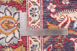 Corner detail of 2000s Kashan rug showing border pattern and Wool pile