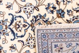 Corner detail of 2000s Kashan rug showing border pattern and Wool pile