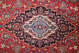 Corner detail of 2000s Kashan rug showing border pattern and Wool pile