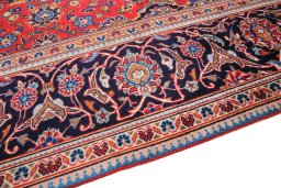 Backside of handmade 2000s Kashan rug showing knot structure and weave density