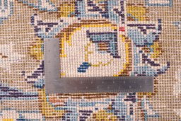 Backside of handmade 1970s Kashan rug showing knot structure and weave density