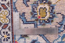 Corner detail of 2000s Kashan rug showing border pattern and Wool pile