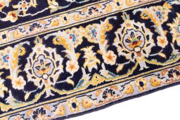 Backside of handmade 1975s Kashan rug showing knot structure and weave density