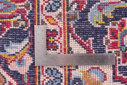 Corner detail of 2000s Kashan rug showing border pattern and Wool pile