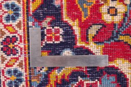 Corner detail of 2000s Kashan rug showing border pattern and Wool pile