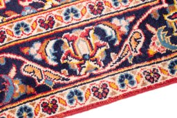 Backside of handmade 2000s Kashan rug showing knot structure and weave density