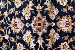 Corner detail of 2003s Kashan rug showing border pattern and Wool pile