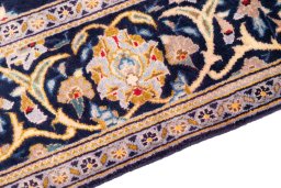 Backside of handmade 2003s Kashan rug showing knot structure and weave density