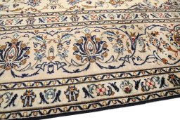 Backside of handmade 1990s Kashan rug showing knot structure and weave density