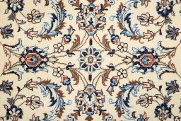 Corner detail of 2000s Kashan rug showing border pattern and Wool pile