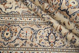 Corner detail of 2000s Kashan rug showing border pattern and Wool pile