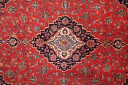 Corner detail of 2000s Kashan rug showing border pattern and Wool pile